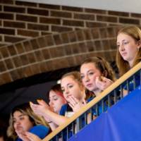 Thompson scholars clapping. They are on a balcony looking over dedication event.